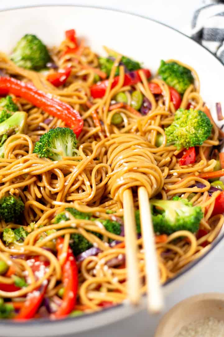 Close up shot of veggie lo mein garnished with sesame seeds