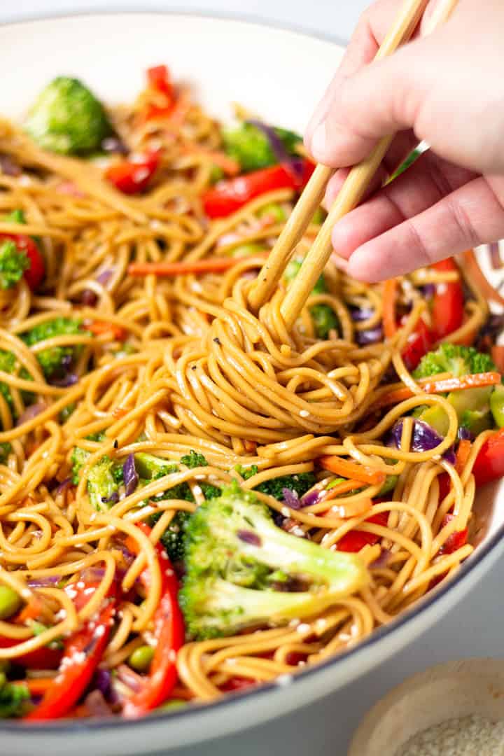 Close up shot of veggie lo mein garnished with sesame seeds