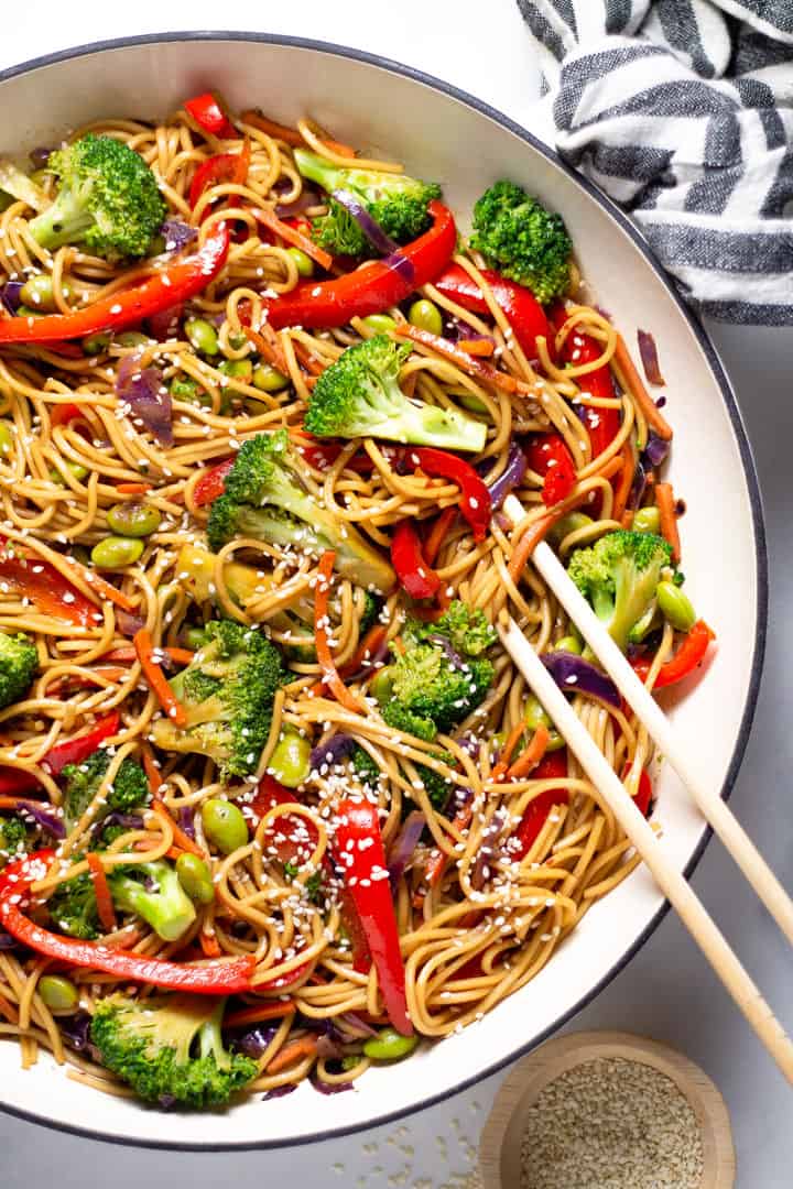 Close up shot of veggie lo mein garnished with sesame seeds