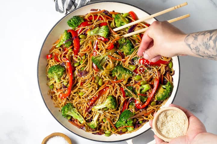 Close up shot of veggie lo mein garnished with sesame seeds