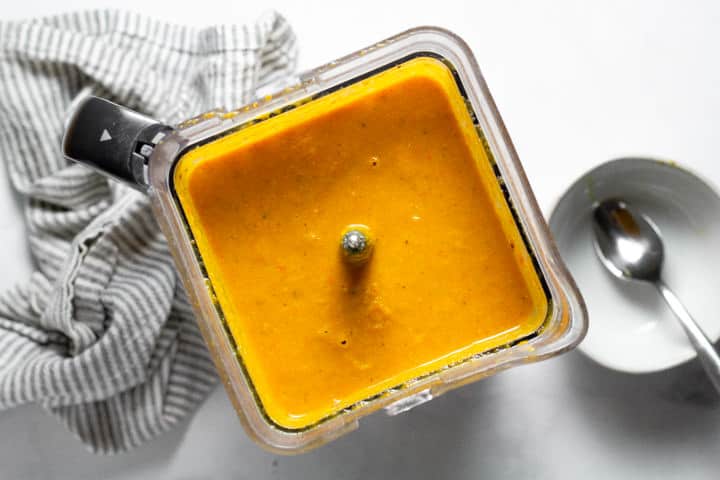 Overhead shot of a blender filled with roasted squash soup