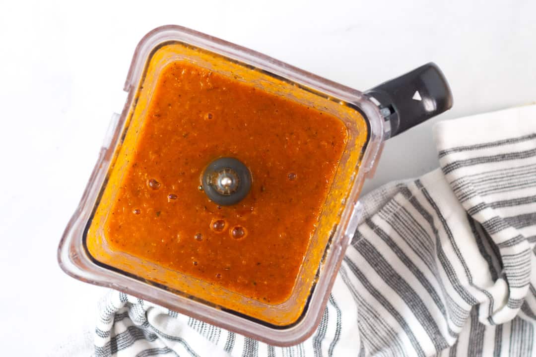 Ninja blender filled with vegan tomato soup blended and smooth