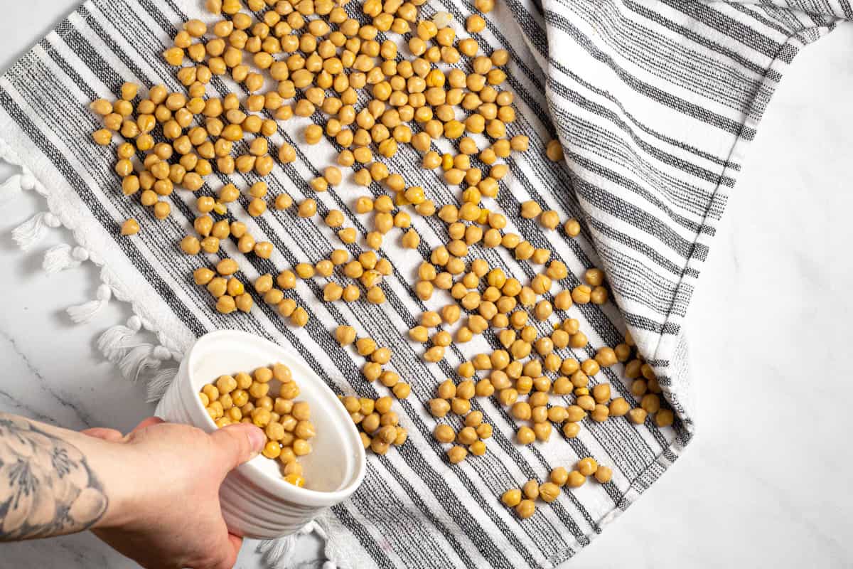 Striped towel with chickpeas drying on it 