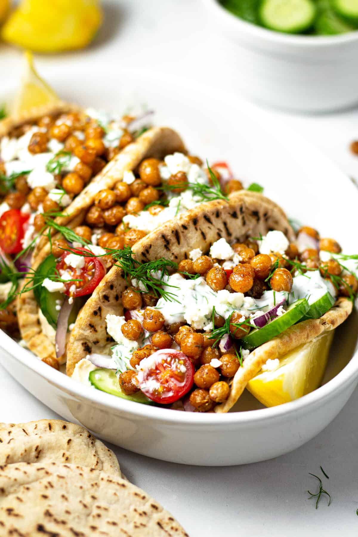Close up shot of chickpea gyros loaded with tzatziki and dill