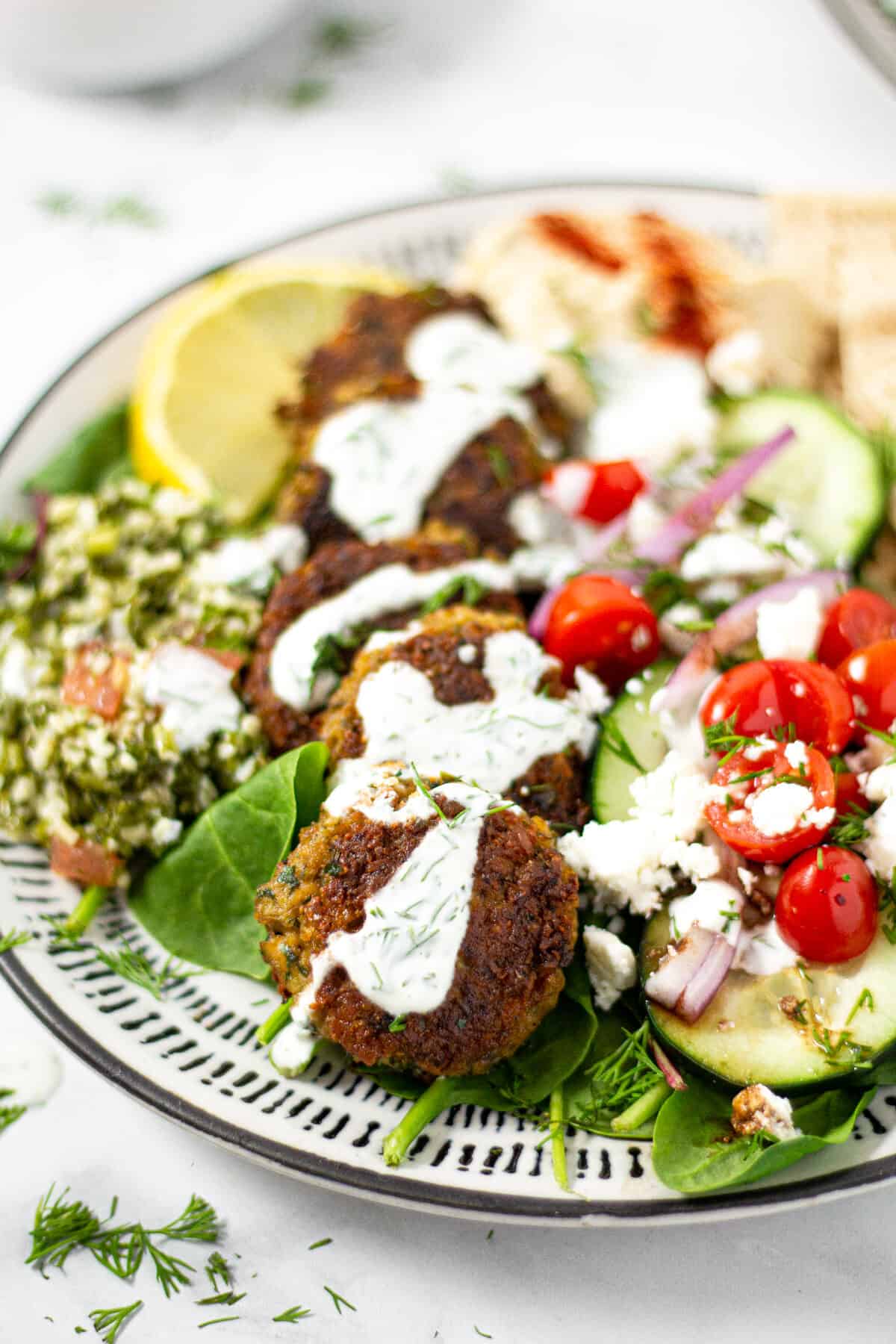 A plate filled with vegan falafel tzatziki and pita bread