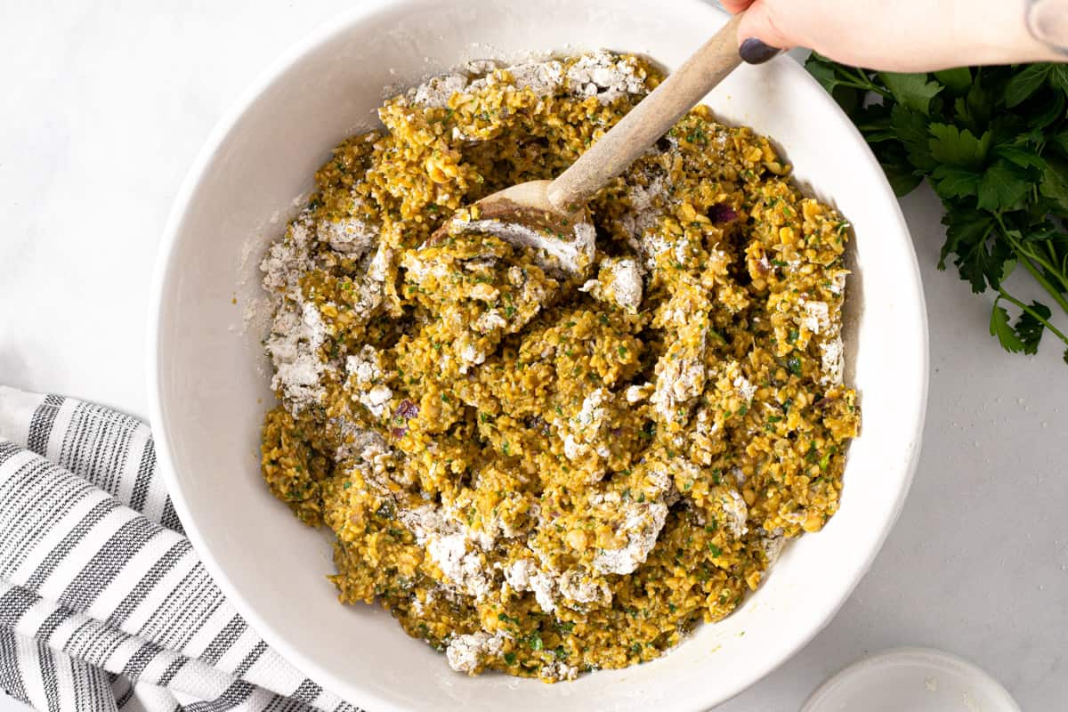 Large white bowl filled with ingredients to make falafel