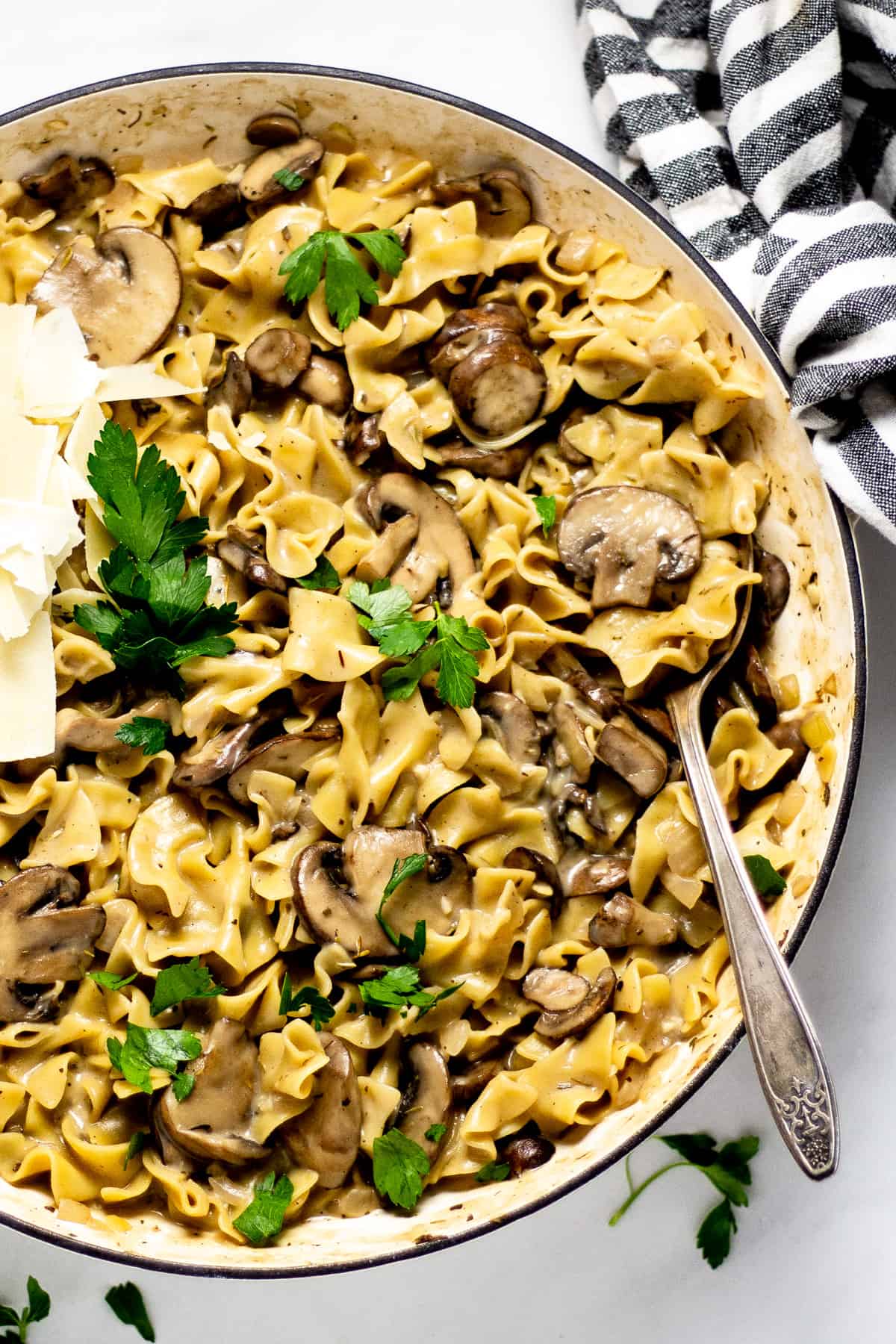 Overhead shot of a the finished dish one pot mushroom stroganoff garnished with fresh parsley and Parmesan