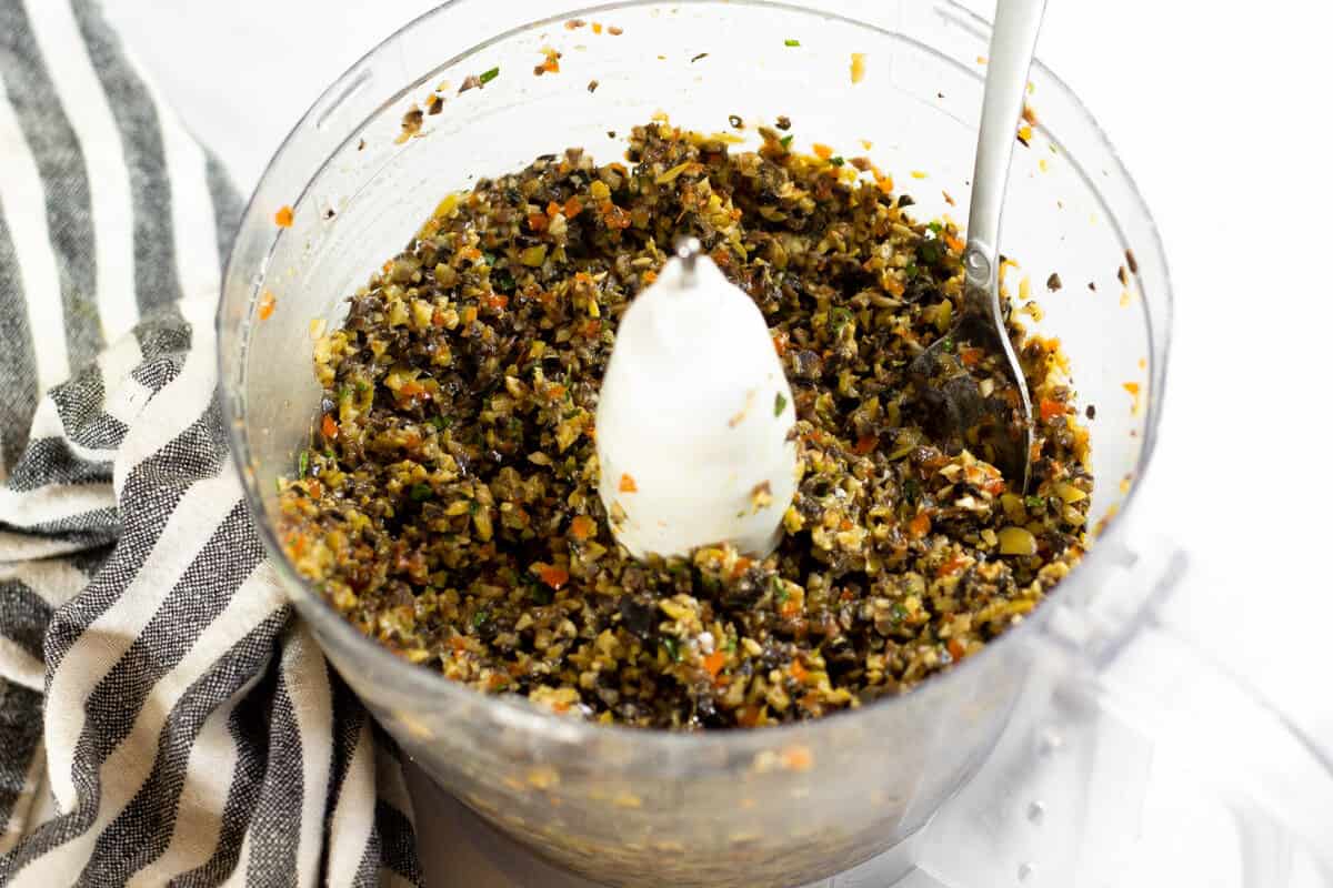 Food processor filled with homemade olive tapenade