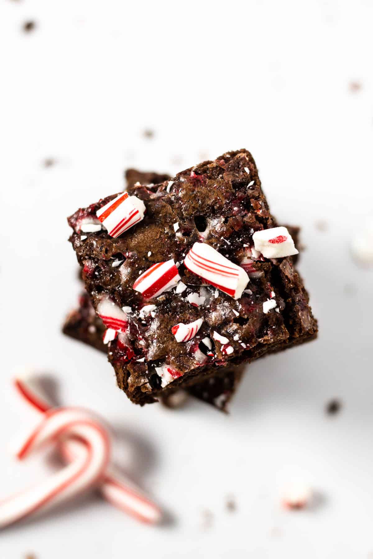 Overhead shot of a stack of peppermint brownies garnished with crushed candy canes