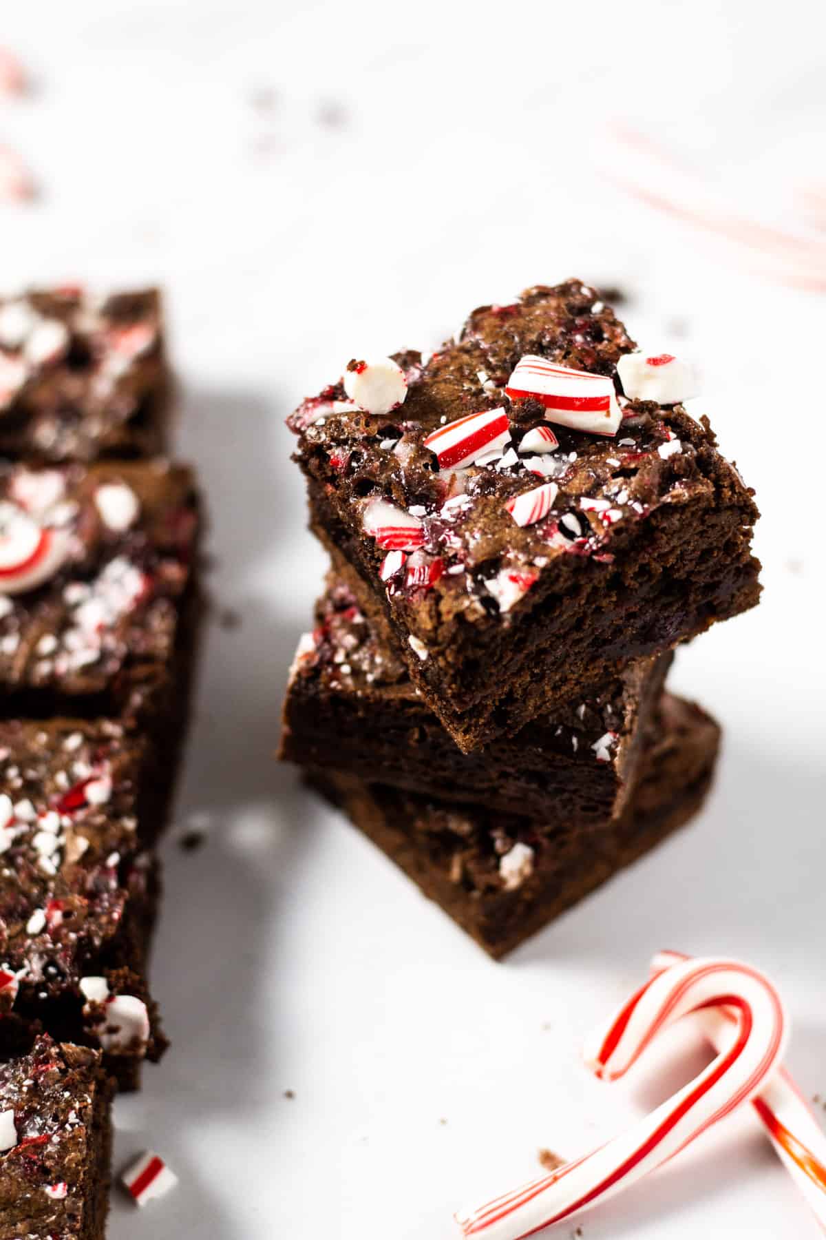 Stacked peppermint brownies garnished with crushed candy canes