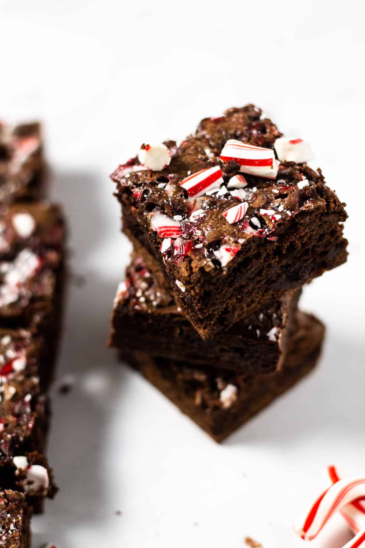 Stacked peppermint brownies garnished with crushed candy canes