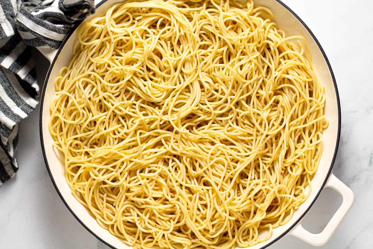 Large white pan filled with cooked spaghetti