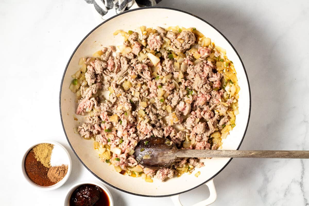 Overhead shot of a white pan with ground turkey and sauteed onion