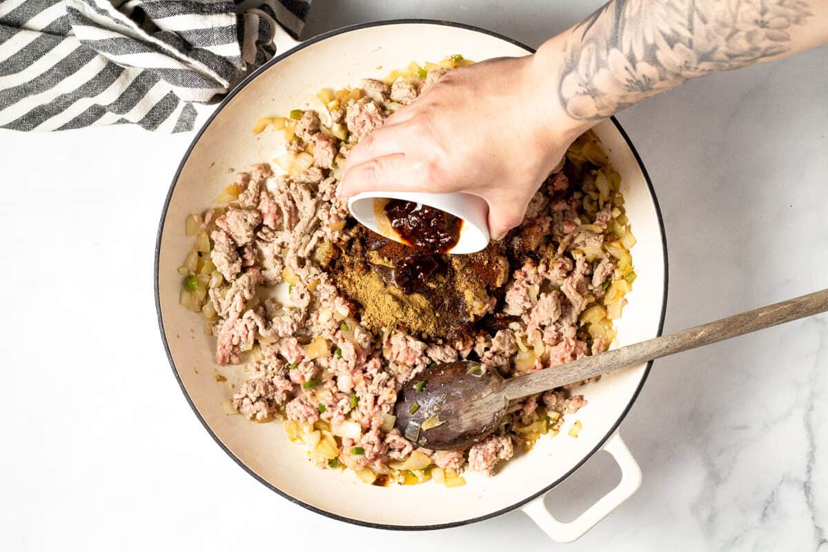 Overhead shot of a white pan filled with ground turkey and spices
