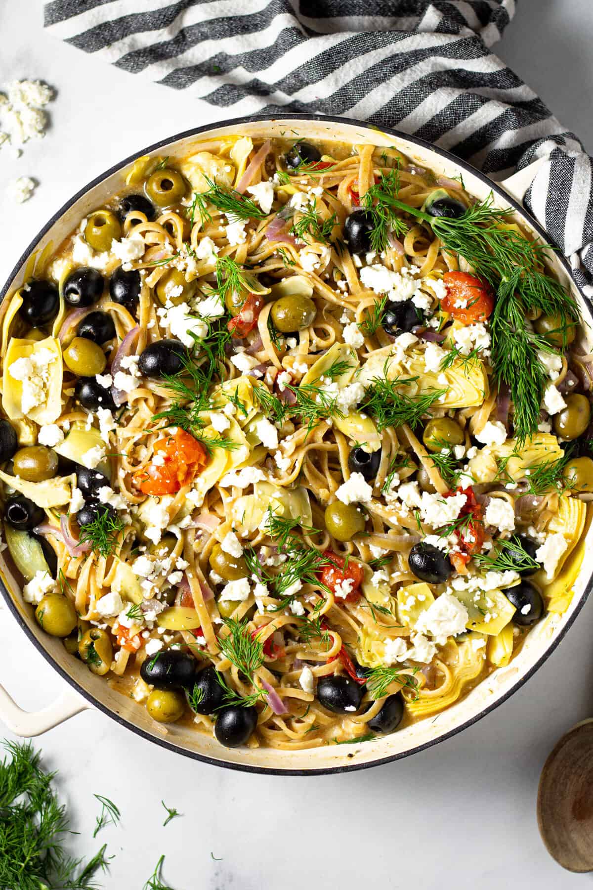 Overhead shot of a pot filled with Greek one pot pasta loaded with veggies