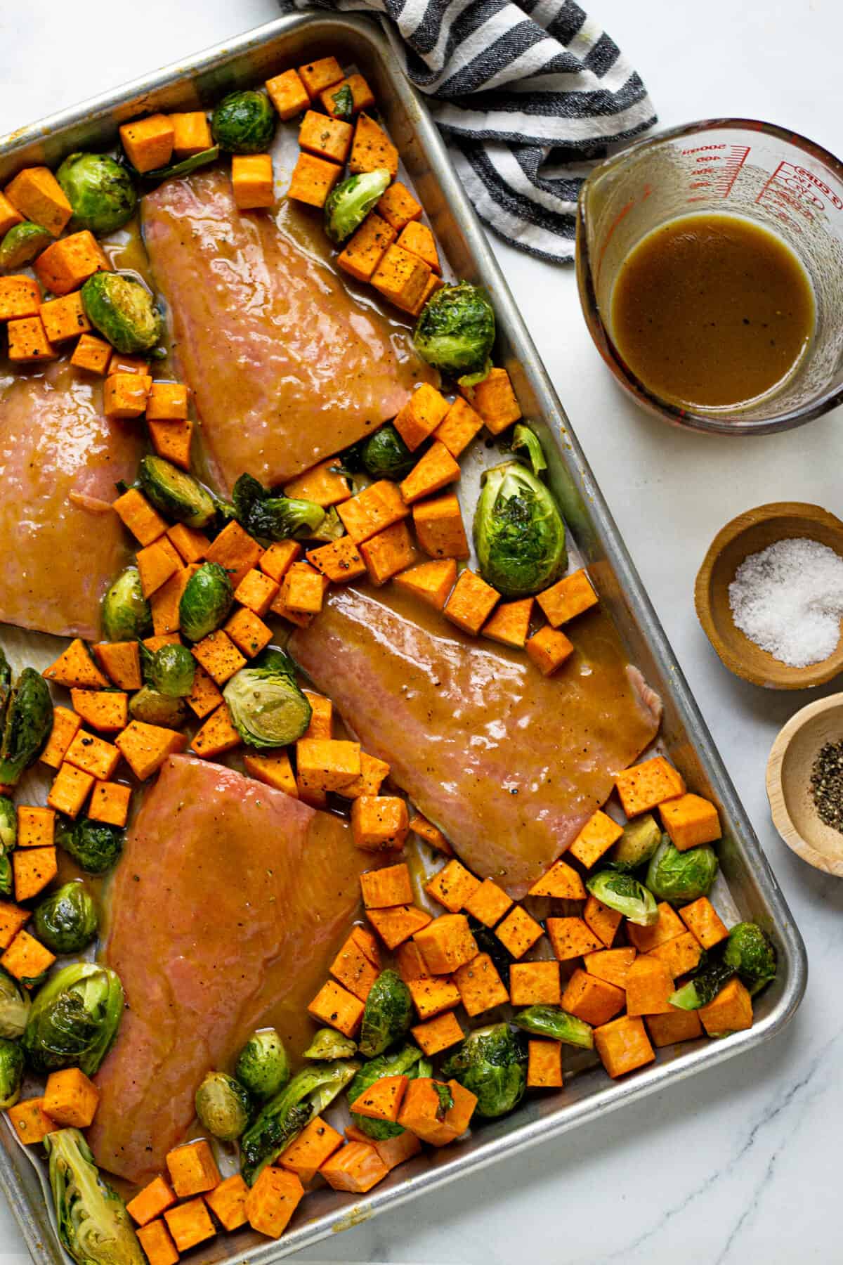 Overhead shot of a sheet pan filled with maple mustard salmon and veggies