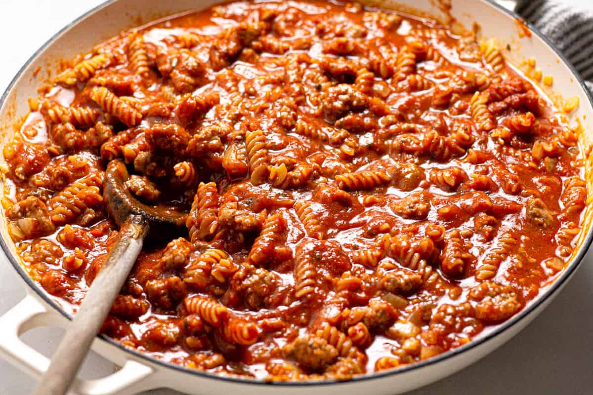 Large white pan with filled with spaghetti sauce and noodles