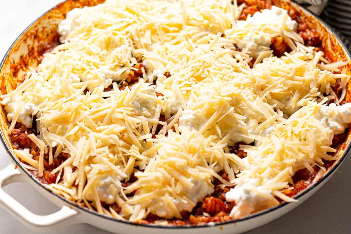 Large white pan with filled with ingredients to make stove top lasagna