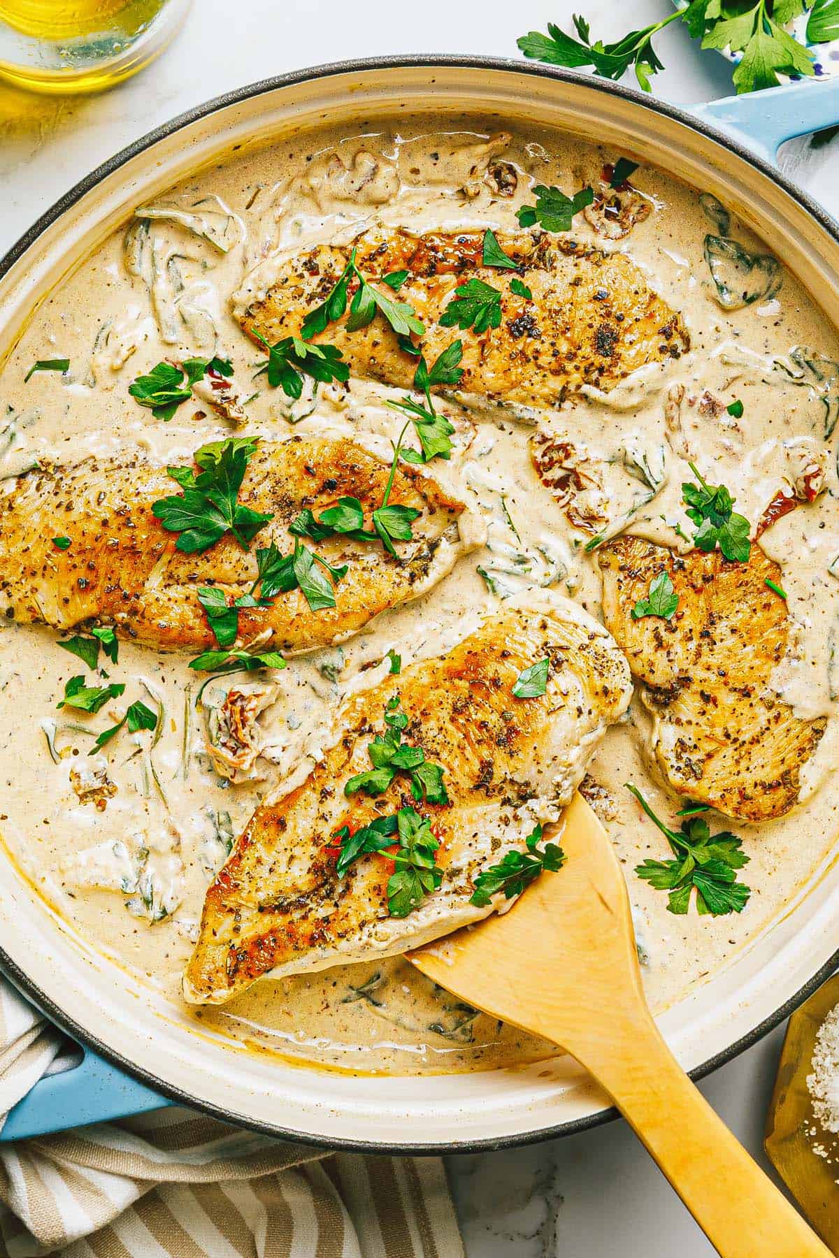 Large pan filled with creamy Tuscan chicken.
