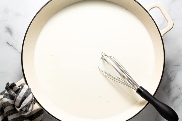 Large white pot with a roux and milk in it 