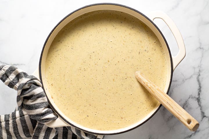 Overhead shot of a pot filled with creamy potato soup 