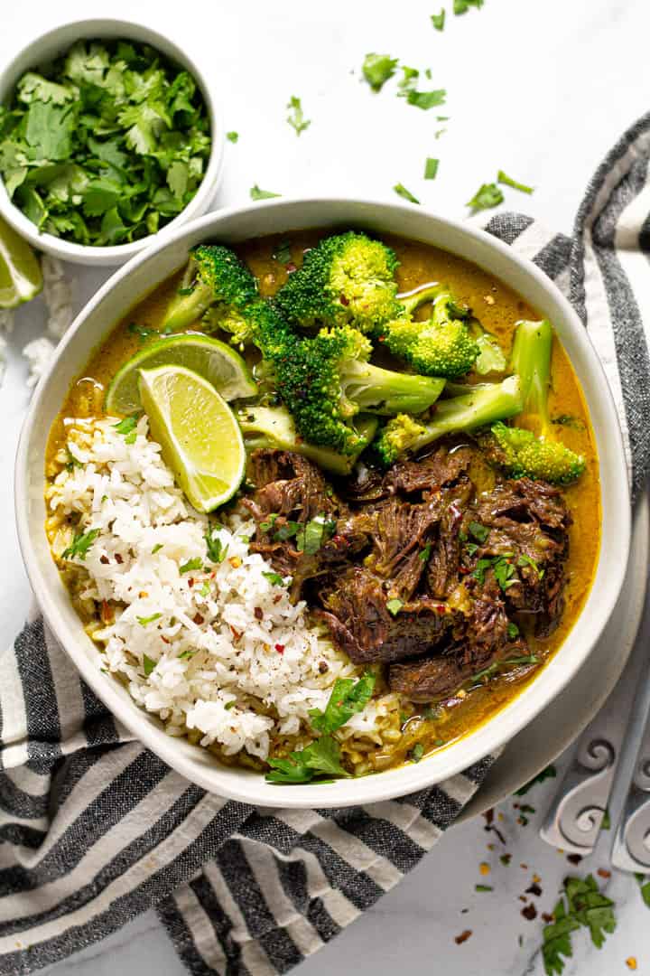 Overhead shot of a bowl of curried beef served over rice and garnished with cilantro