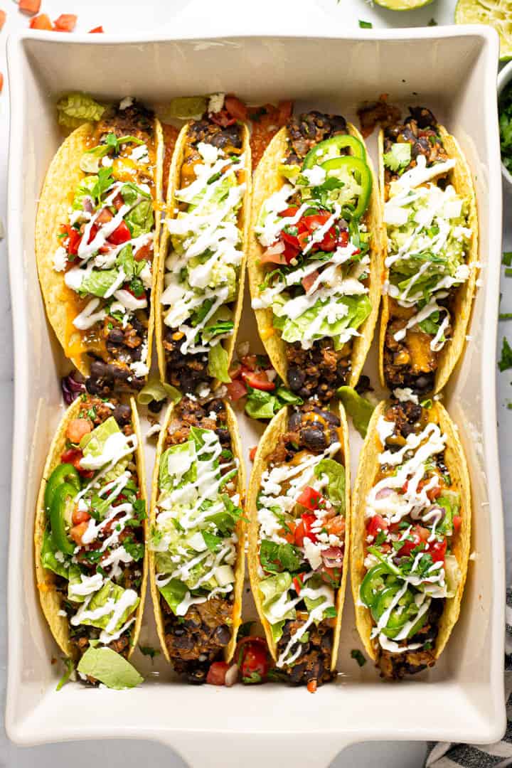 Overhead shot of a 9x13 pan filled with baked black tacos 