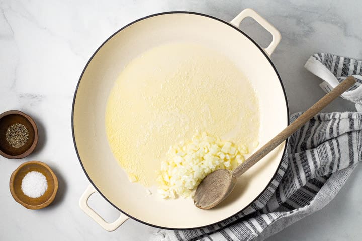 Large white pot with butter and onions in it