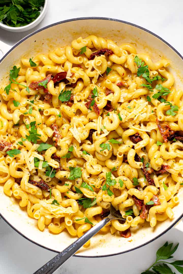 Overhead shot of a pan filled with smoked gouda mac and cheese garnished with fresh parsley