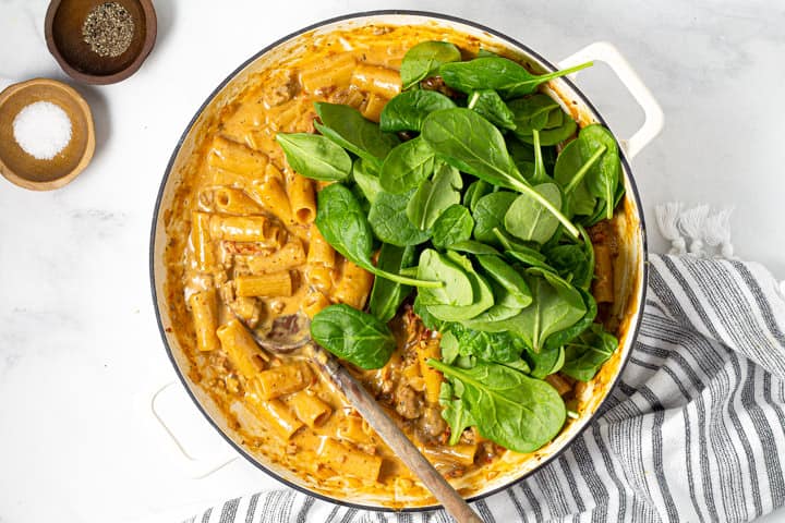 Fresh spinach rigatoni and sauce in a large pot