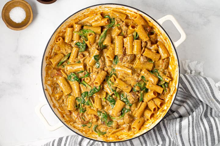 Overhead shot of a large white pot filled with saucy rigatoni