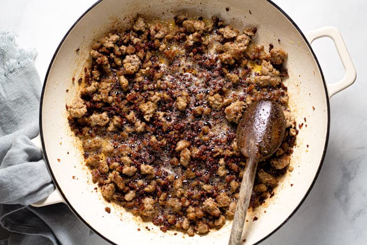Large white pot filled with crispy cooked ground pork