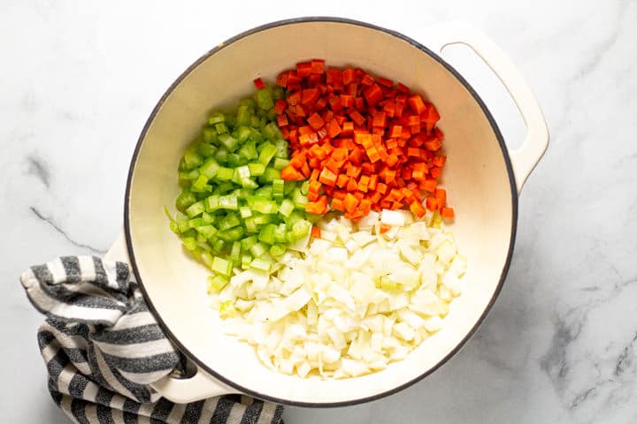 Large white pot filled with diced celery carrots and onion 