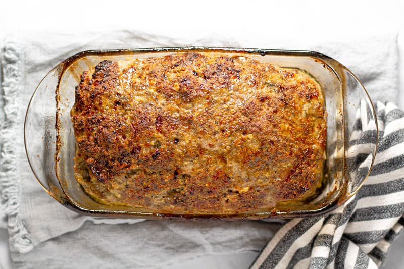 Glass loaf pan filled with baked Italian meatloaf
