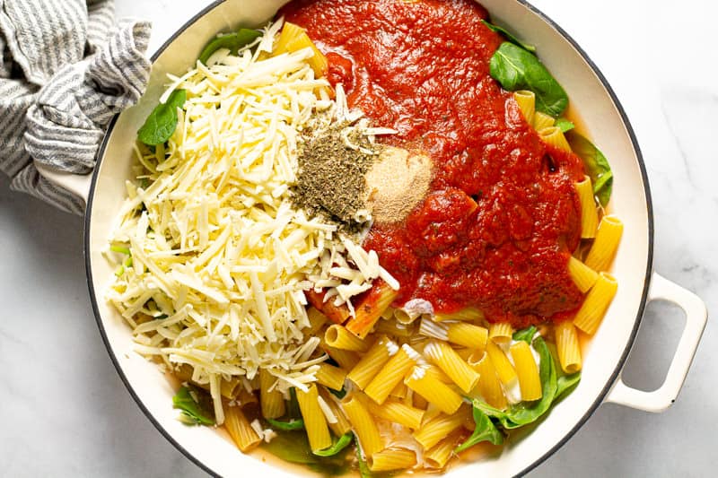 Overhead shot of a baking dish filled with ingredients to make baked pasta