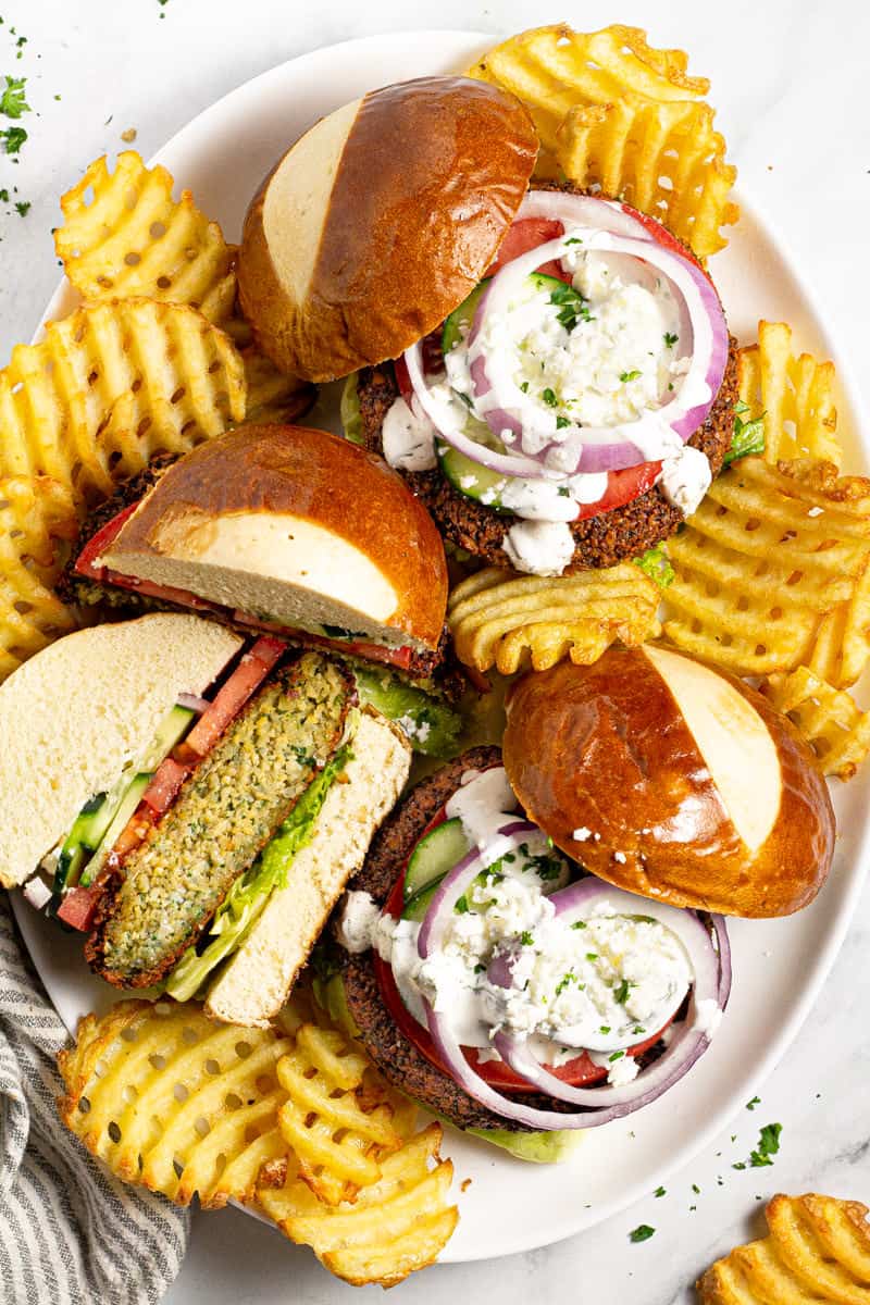 Overhead shot of a platter filled with falafel burgers and waffle fries