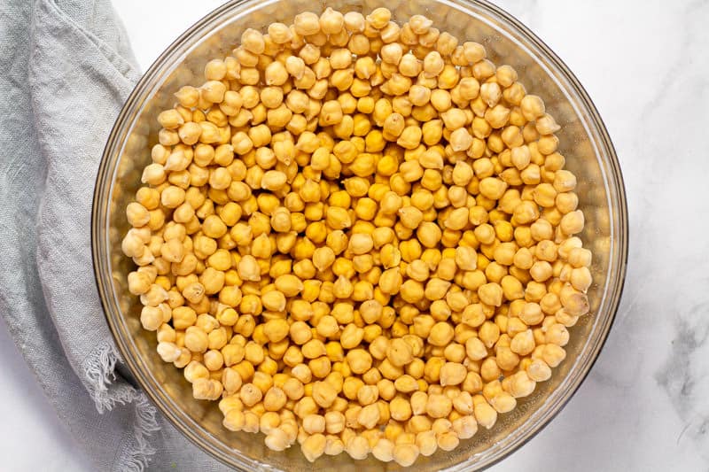 Large glass bowl with soaked chickpeas in water