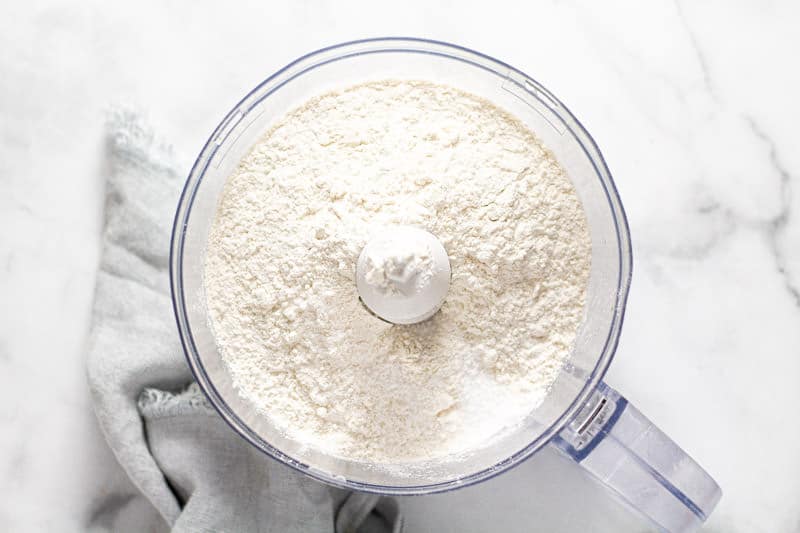 Overhead shot of a food processor with flour and salt in it 