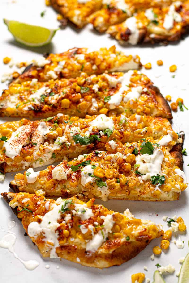 Close up shot of Mexican street corn pizza garnished with fresh chopped cilantro 
