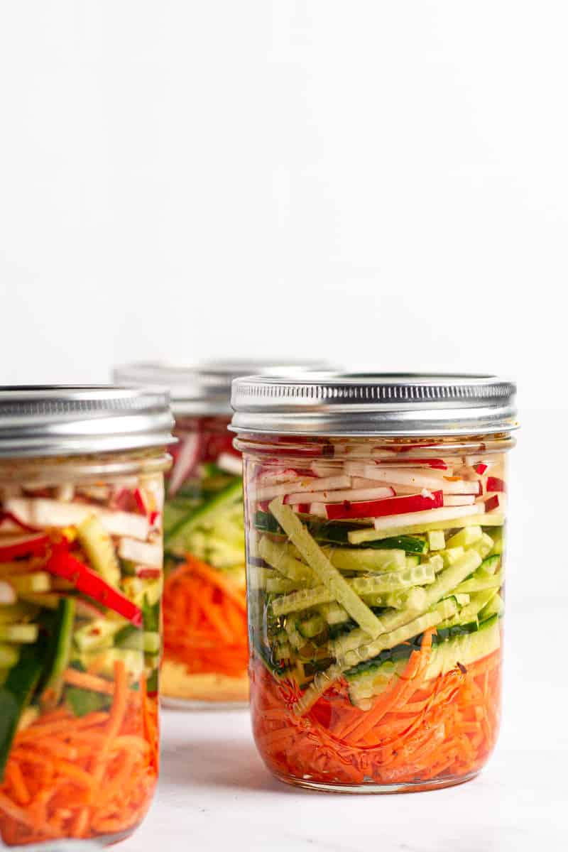 Close up shot of a few jars of pickled veggies 