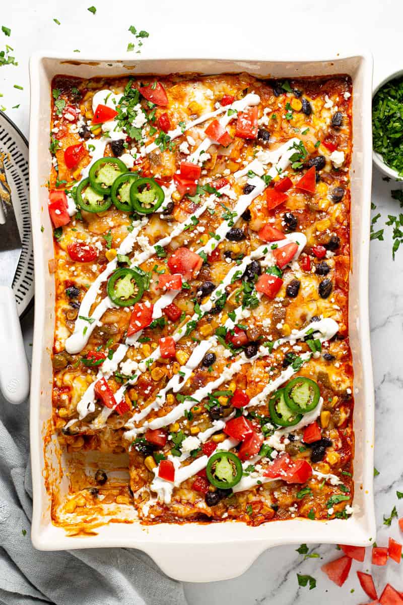 Overhead shot of a pan filled with enchilada casserole garnished with fresh chopped cilantro