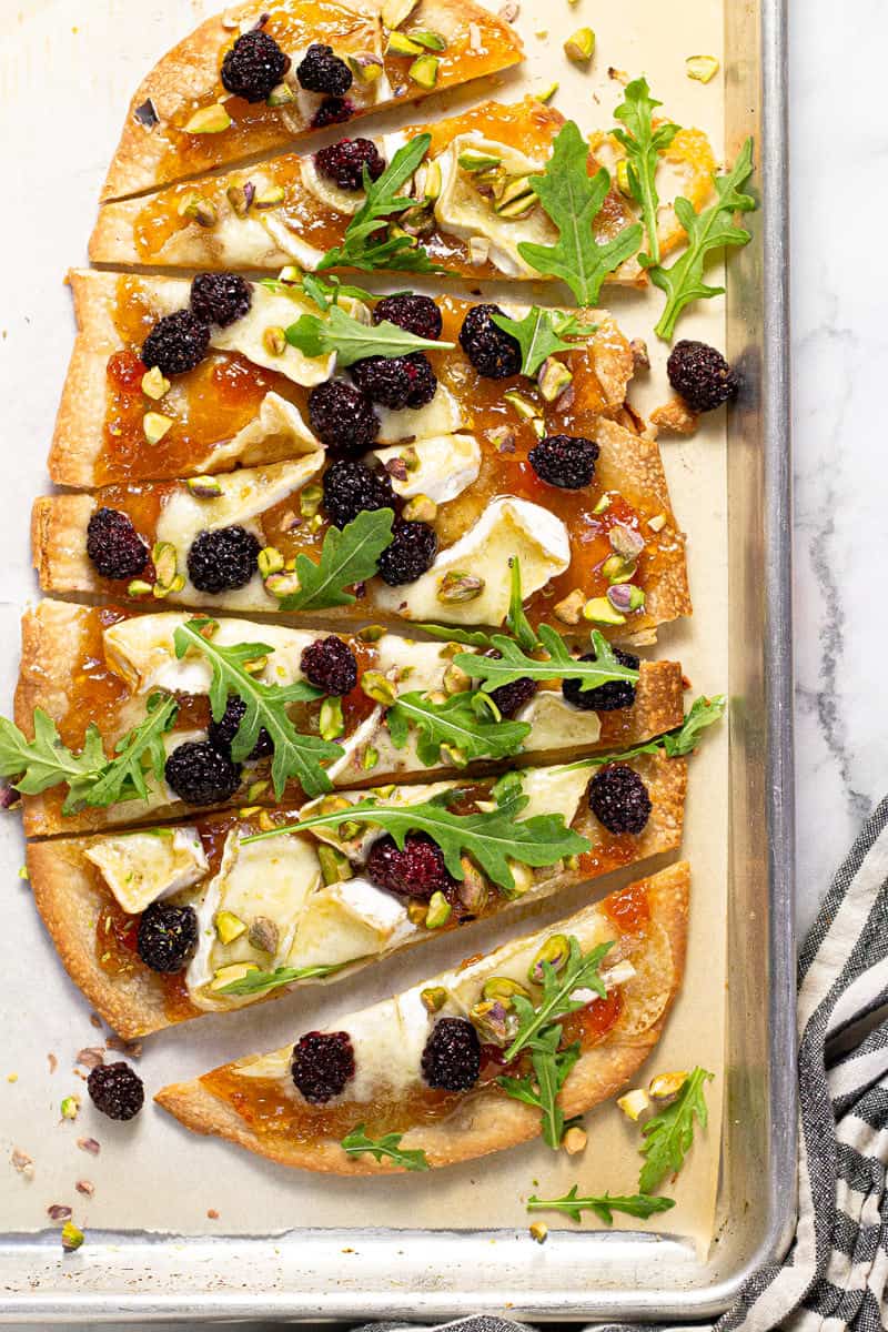 Brie blackberry flatbread on a parchment lined baking sheet