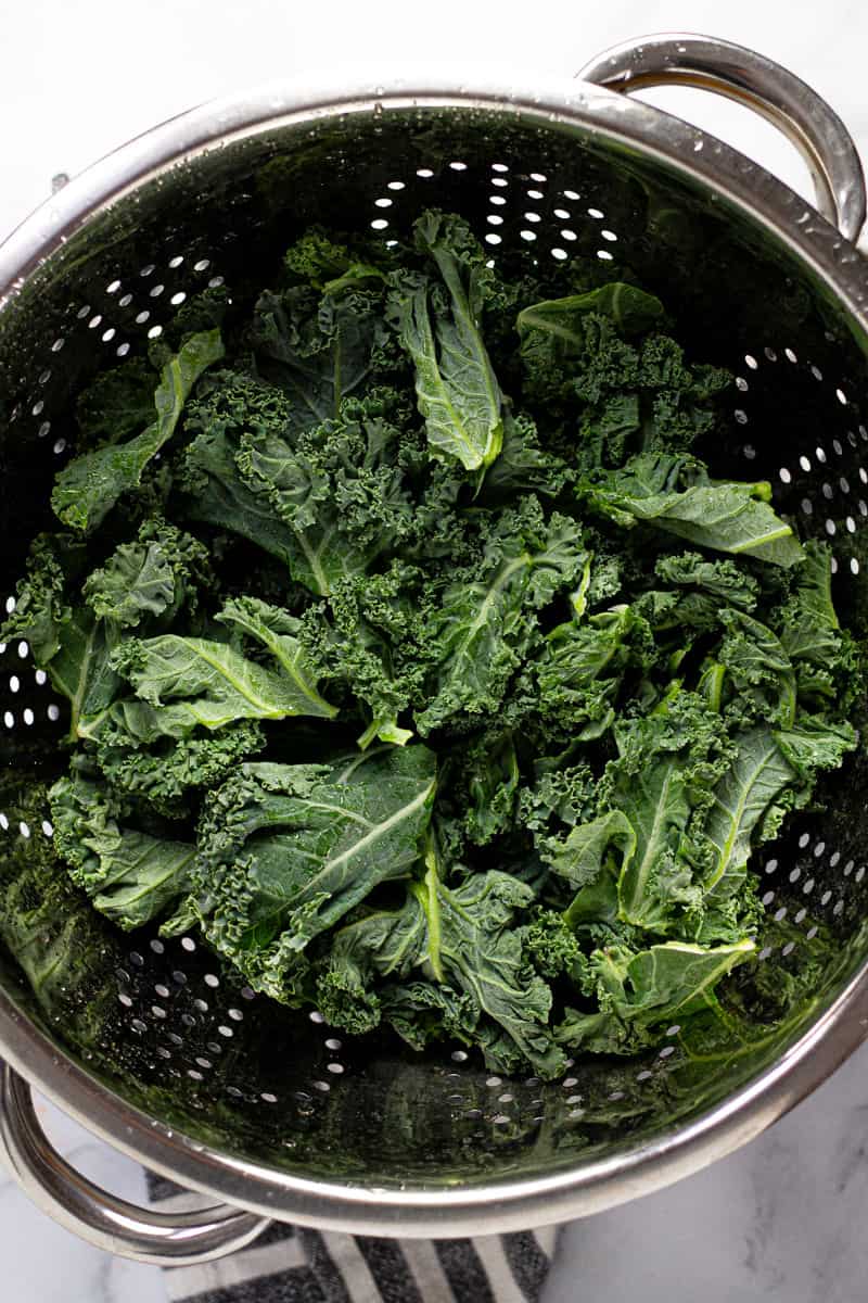 Metal strainer with freshly chopped kale