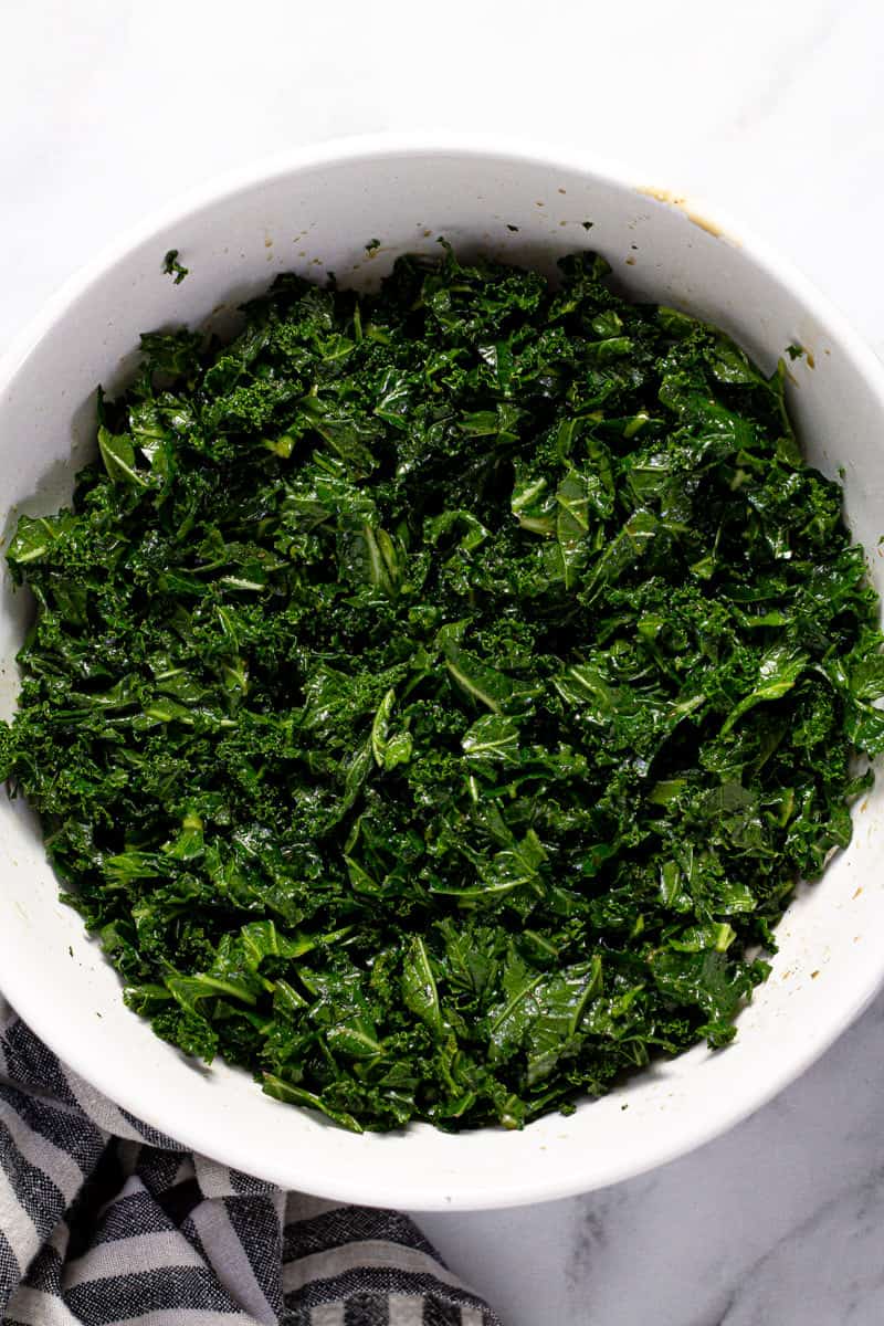 White bowl filled with massaged kale