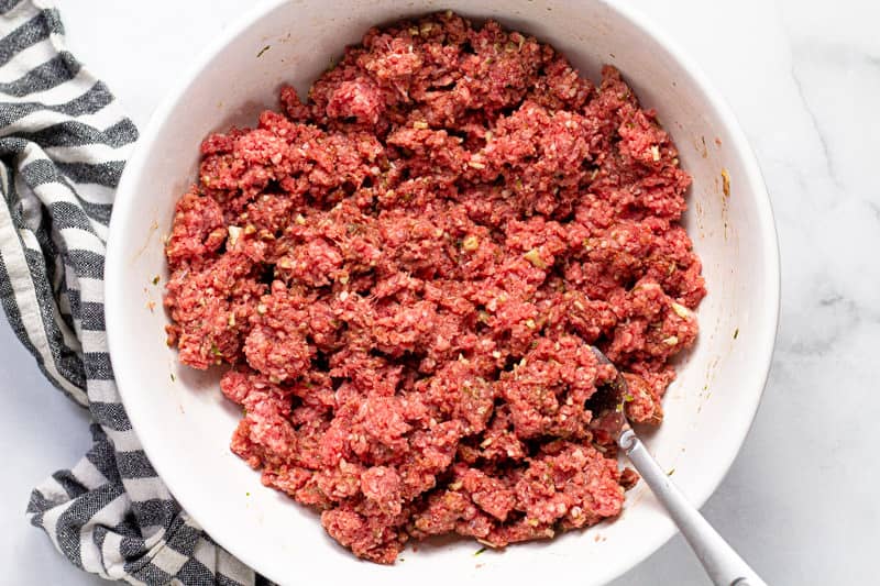Large white bowl with ingredients to make Banh Mi burgers patties