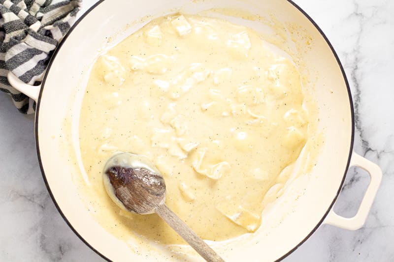 Large white pan filled with Brie cheese sauce