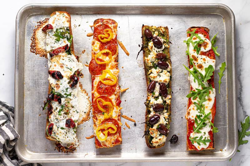 Freshly baked French bread pizza on a baking sheet