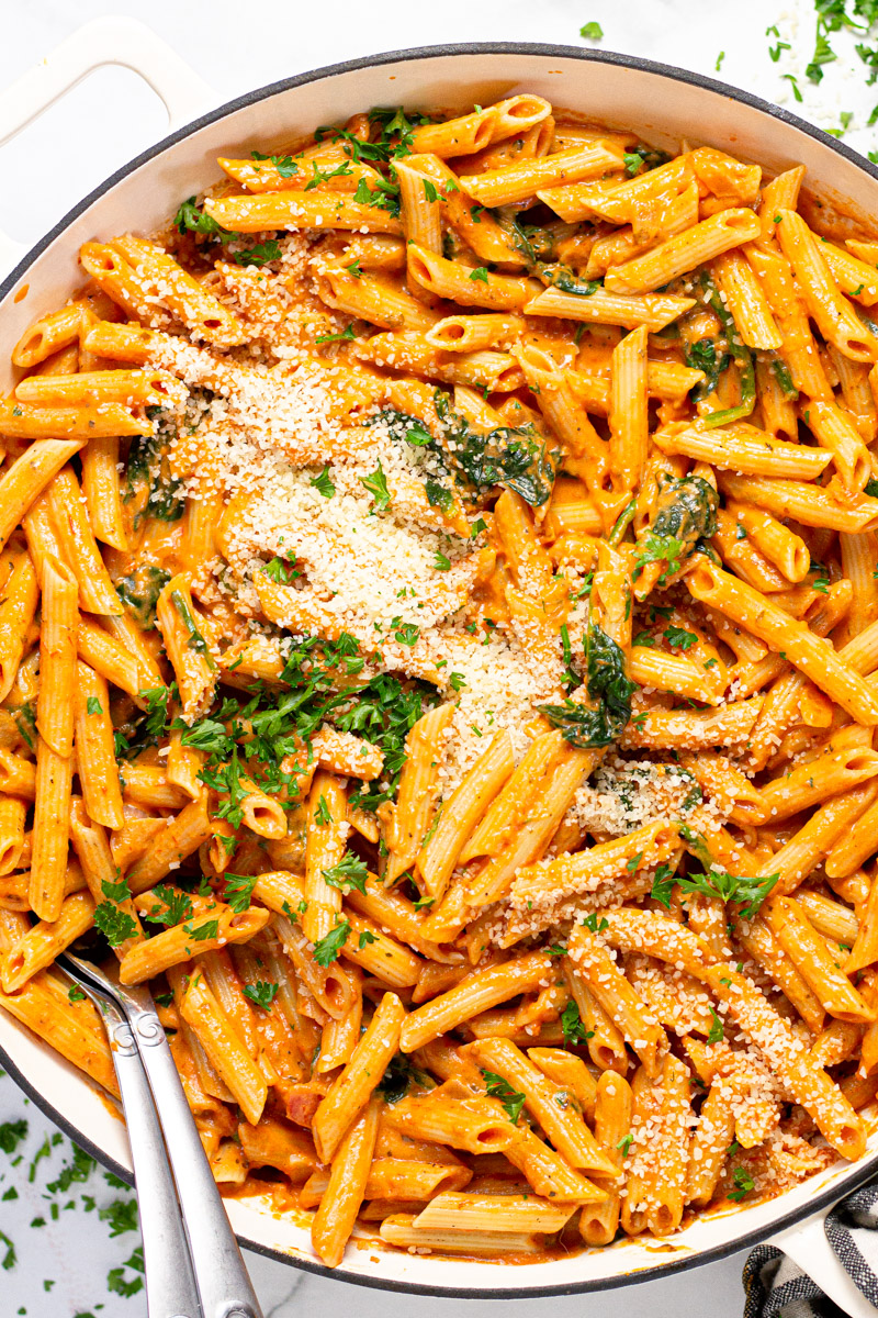 Large white pan with homemade penne rosa garnished with fresh parsley 