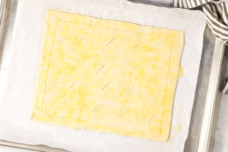 Puff pastry sheet on a parchment lined baking sheet