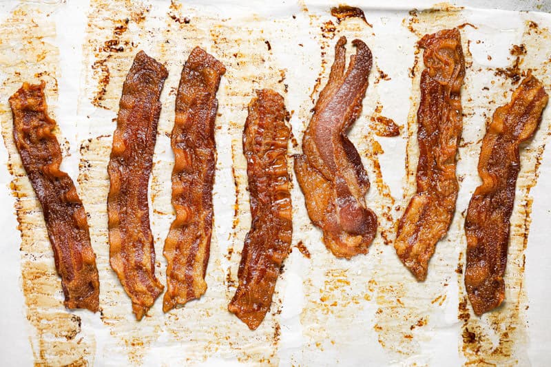 Crispy bacon on a parchment lined baking sheet